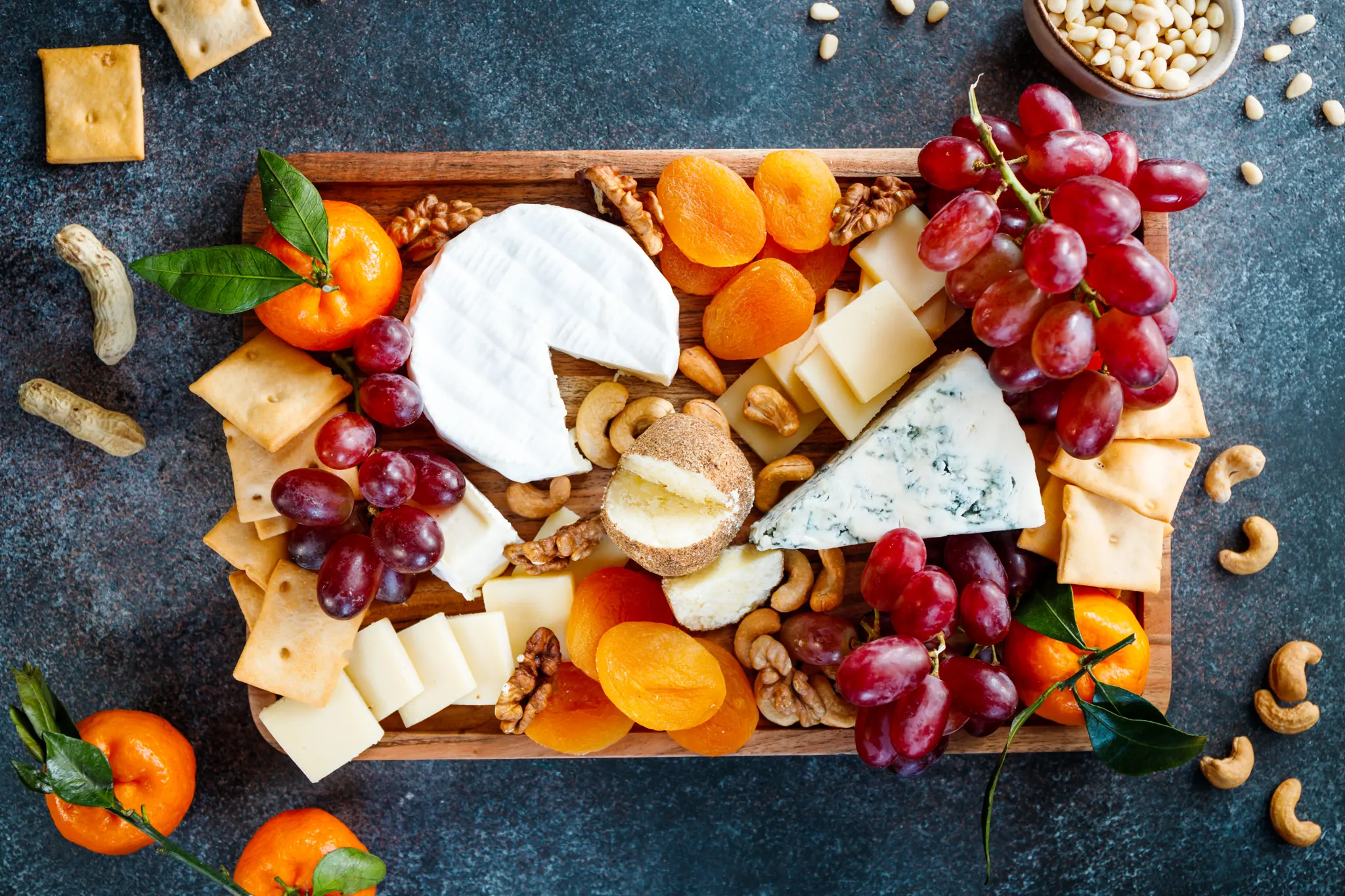 Cheese board with fruit and crackers