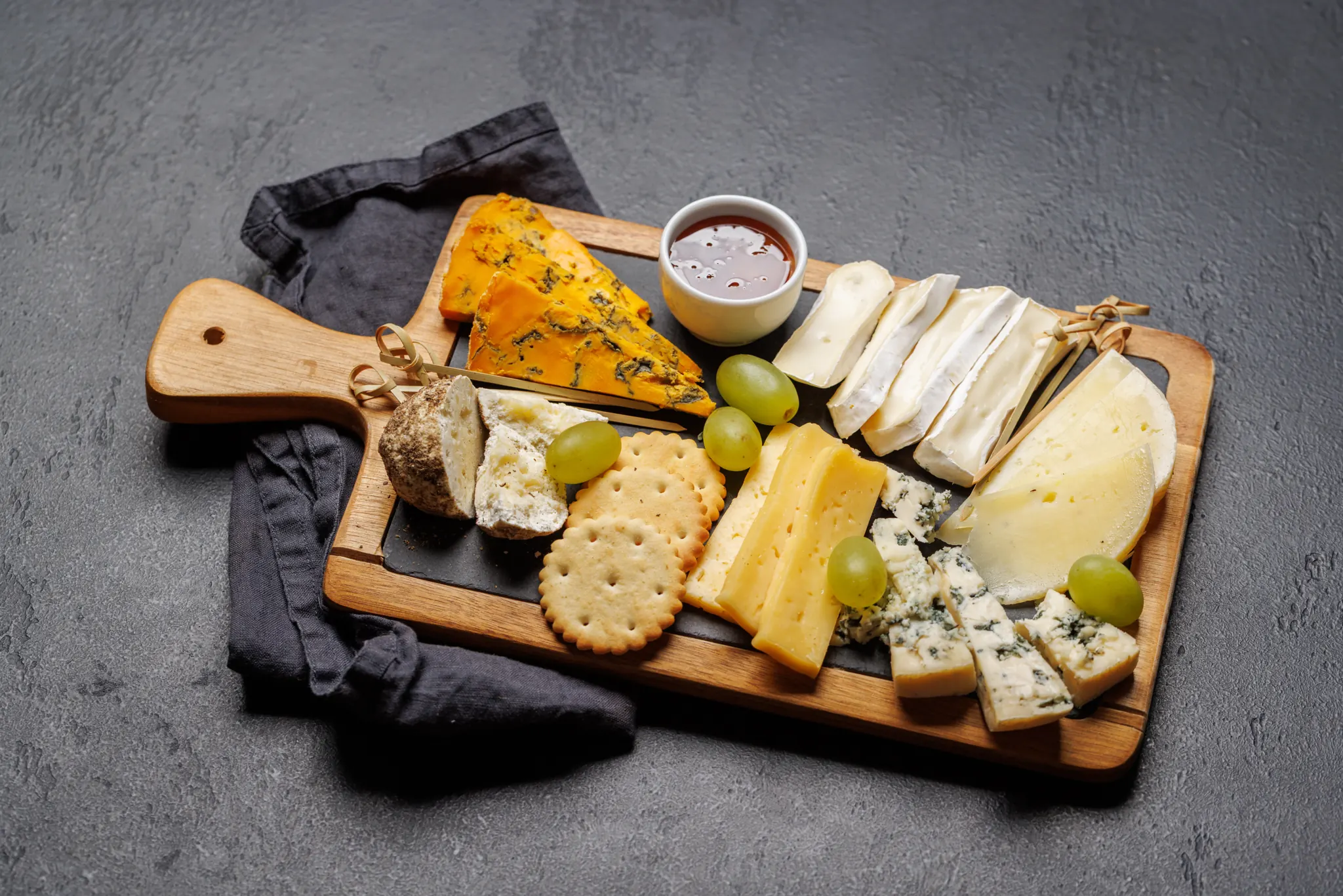 Artisan cheese platter with crackers and grapes