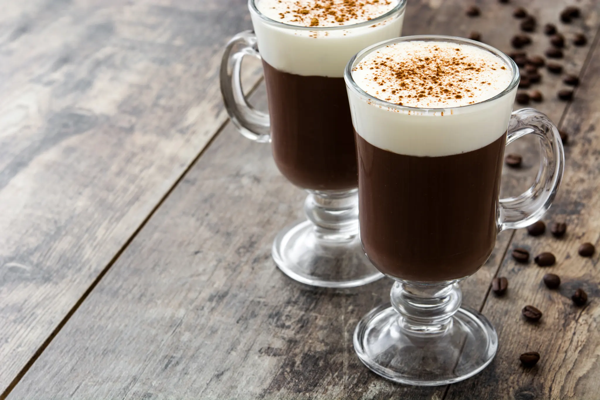 Two glasses of Irish coffee with coffee beans